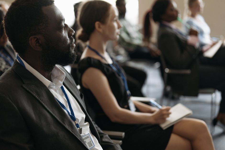 A diverse group of professionals attentively listening at a conference seminar.