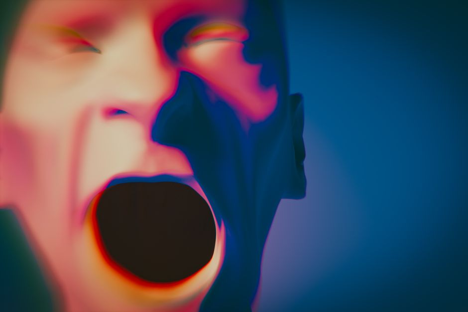 A vibrant abstract depiction of a human face conveying strong emotion.
