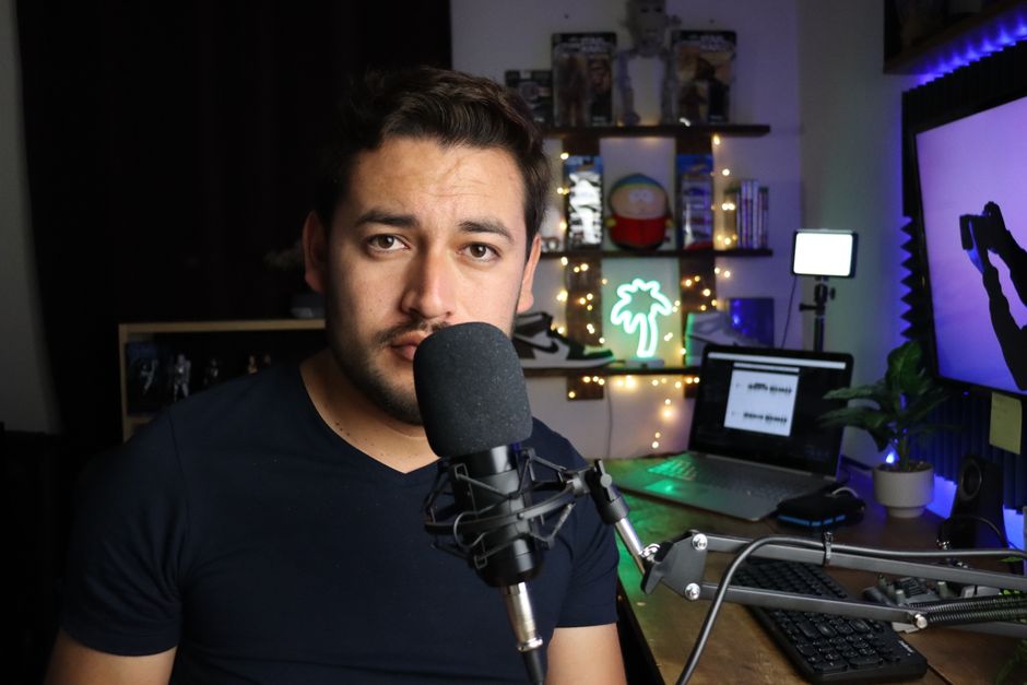 Podcaster in a stylish home studio with microphone and neon lights in Santiago de QuerΓ©taro, Mexico.